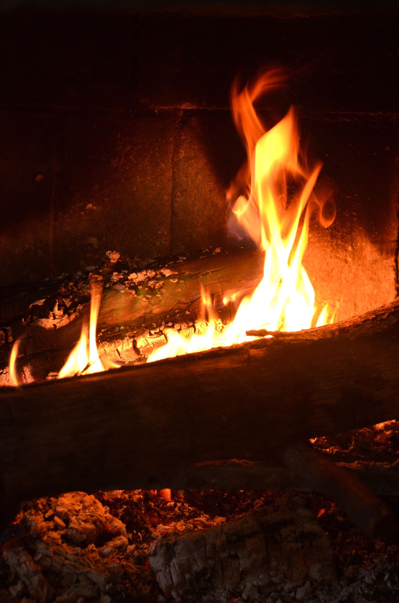 A lit fireplace in a rustic Cypriot tavern.