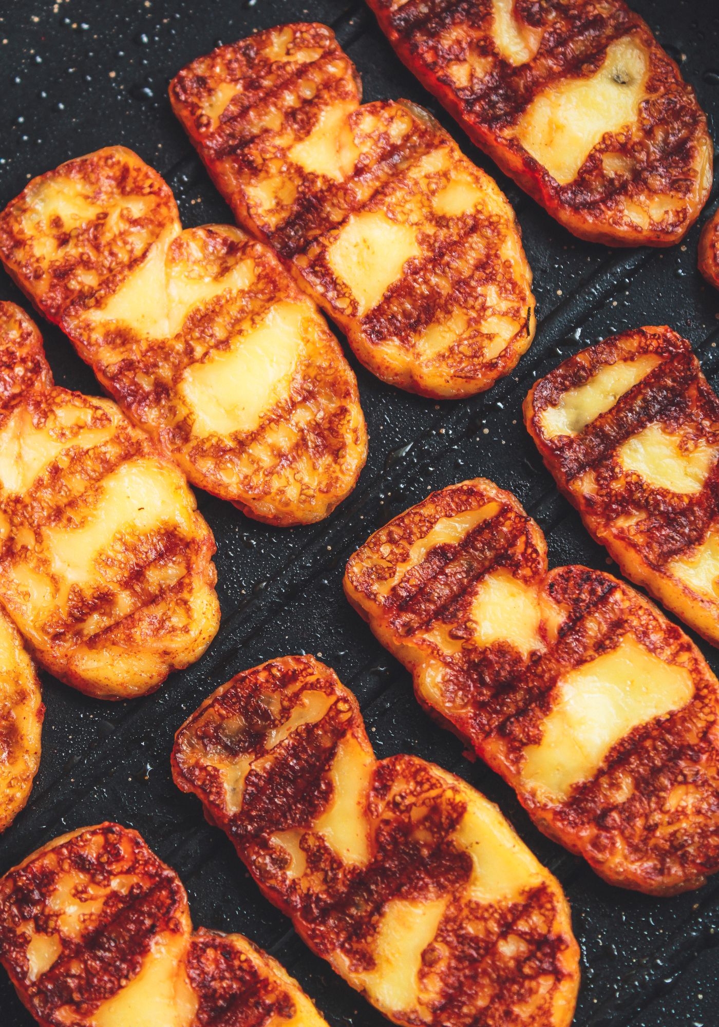 Grilled halloumi cheese with charred edges.