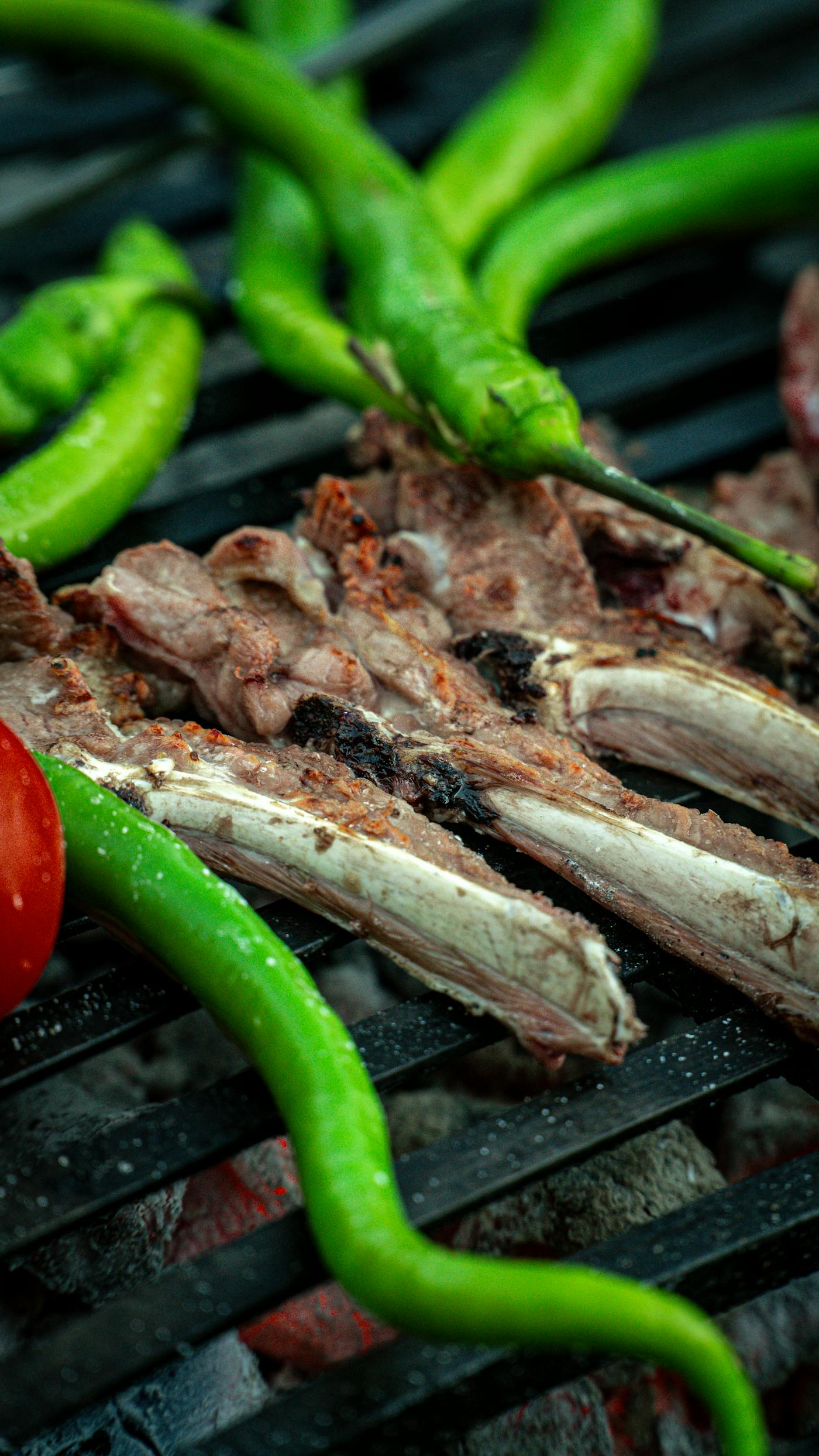 Charcoal grilled lamb chops on a rustic plate.